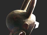 an image of a wooden sculpture of a bird on a black background