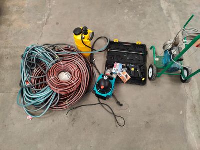 a lot of hoses and other tools on the ground
