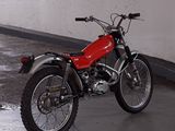 a red dirt bike parked in a parking garage