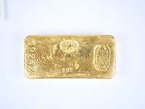 a close up of a gold bar on a white surface