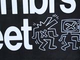 a black sign with white writing on it that says members meet