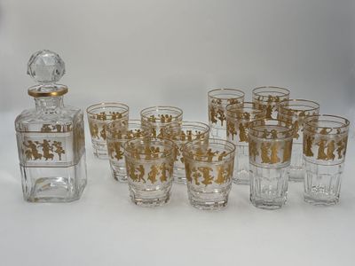 many glasses and a decanter sitting on a table
