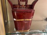 a glass display case with a wooden bucket on it