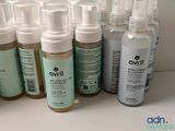 several bottles of skin care products are lined up on a table