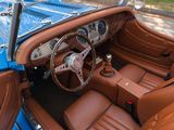 a blue and brown car that is parked on the side of the road