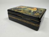 an image of a black and gold box on a white surface