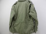 an image of a jacket hanging on a wall on a hanger