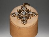 an image of a wooden box with a ring on top of it