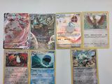 Plusieurs cartes Pokémon sont accrochées au mur d'une pièce.