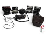 a lot of cameras that are sitting on a white surface