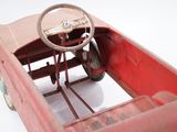 a red toy car with a steering and a steering wheel