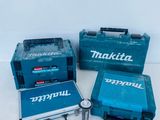 three makita tools are sitting on a white surface