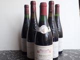 several bottles of wine are lined up on a table