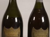 two bottles of wine sitting next to each other on a table