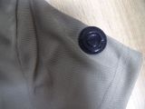 a button on the back of a shirt on a wooden table