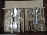 silverware in a wooden box with spoons and spoons in it