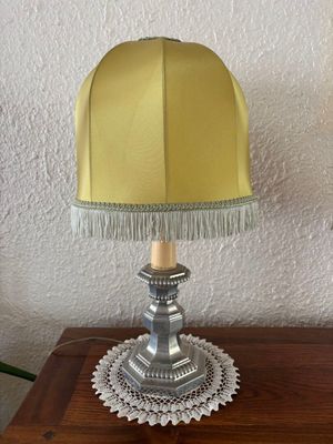 a table with a lamp on it and a doily doily on it