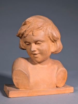 sculpture of a child ' s head on a wooden stand