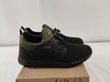 a pair of black and green sneakers sitting on top of a cardboard box