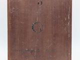 an old suitcase with a hole in the side of it on a white surface