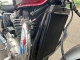 a close up of a motorcycle parked on the side of the road