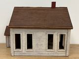 a small model of a white house on a table