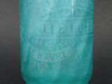 a blue glass vase with a design on it