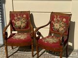 two chairs that are sitting next to each other on the sidewalk