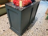 a vase of flowers sitting on top of a kitchen island