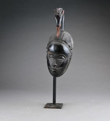 an image of a sculpture of a bird on top of a head