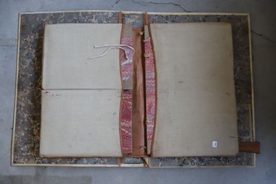 an open book with a red ribbon on top of it