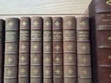 a lot of books that are lined up on a shelf