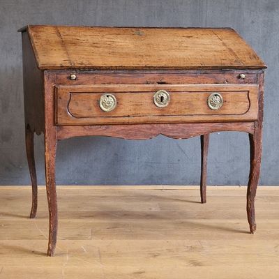 a small wooden table with two drawers on top of it