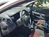 the interior of a car with the door open and a steering wheel in the passenger seat