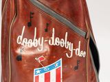 brown leather bag with a logo on the side of it
