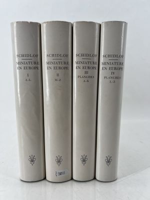a set of four books sitting on top of a white table