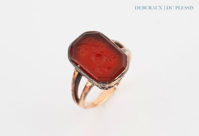 an image of a ring with a red stone in it