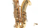 a saxophone that is laying on the ground next to a pair of scissors
