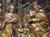 an image of a statue of a man holding a baby and a woman