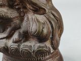 a statue of a man and a woman sitting on top of a vase
