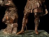 a bronze statue of a man and a dog on a marble base