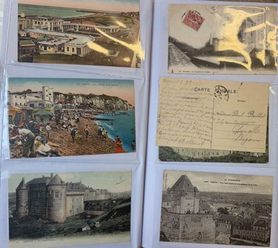some old postcards are sitting on top of a table