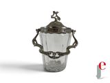 a glass vase with a bird on top of it