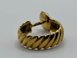 a close up of a gold ring on a white surface