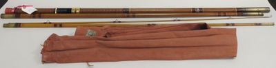 two wooden sticks and a cloth bag on a table