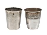 pair of antique silverplated cups with floral designs on the sides
