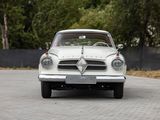a white car that is driving down the street