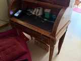 a desk with a chair and a potted plant on top of it