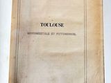 an open book on a white surface with a black and white title