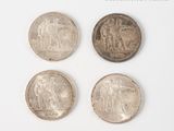 four different types of coins are shown on a white surface